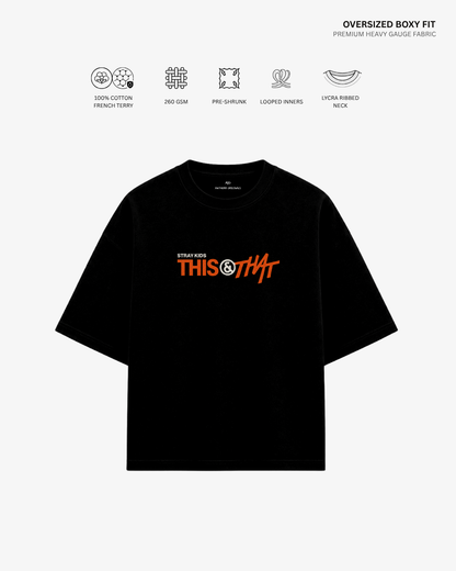 A black oversized short-sleeve T-shirt with a colorful chest graphic reading 'THIS OR THAT' in orange and white, shown on a light gray background with feature icons and text above.