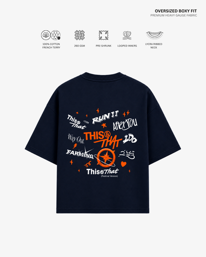 A navy blue oversized boxy-fit T-shirt shown from the back, featuring a colorful graphic print with text and a compass design. The image includes feature icons and text at the top describing the fabric and neck design.