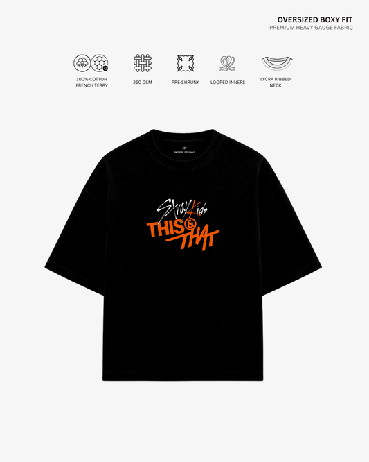A black oversized short-sleeve T-shirt with a colorful graphic on the chest reading 'Stay like THIS & THAT' in white and orange, shown on a light gray background with feature icons and text above.