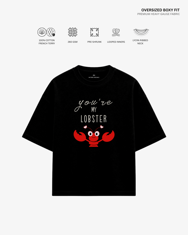 A black oversized short-sleeve T-shirt with a red lobster graphic and the text 'you're MY LOBBER' on the front, shown on a light gray background with feature icons and text above.